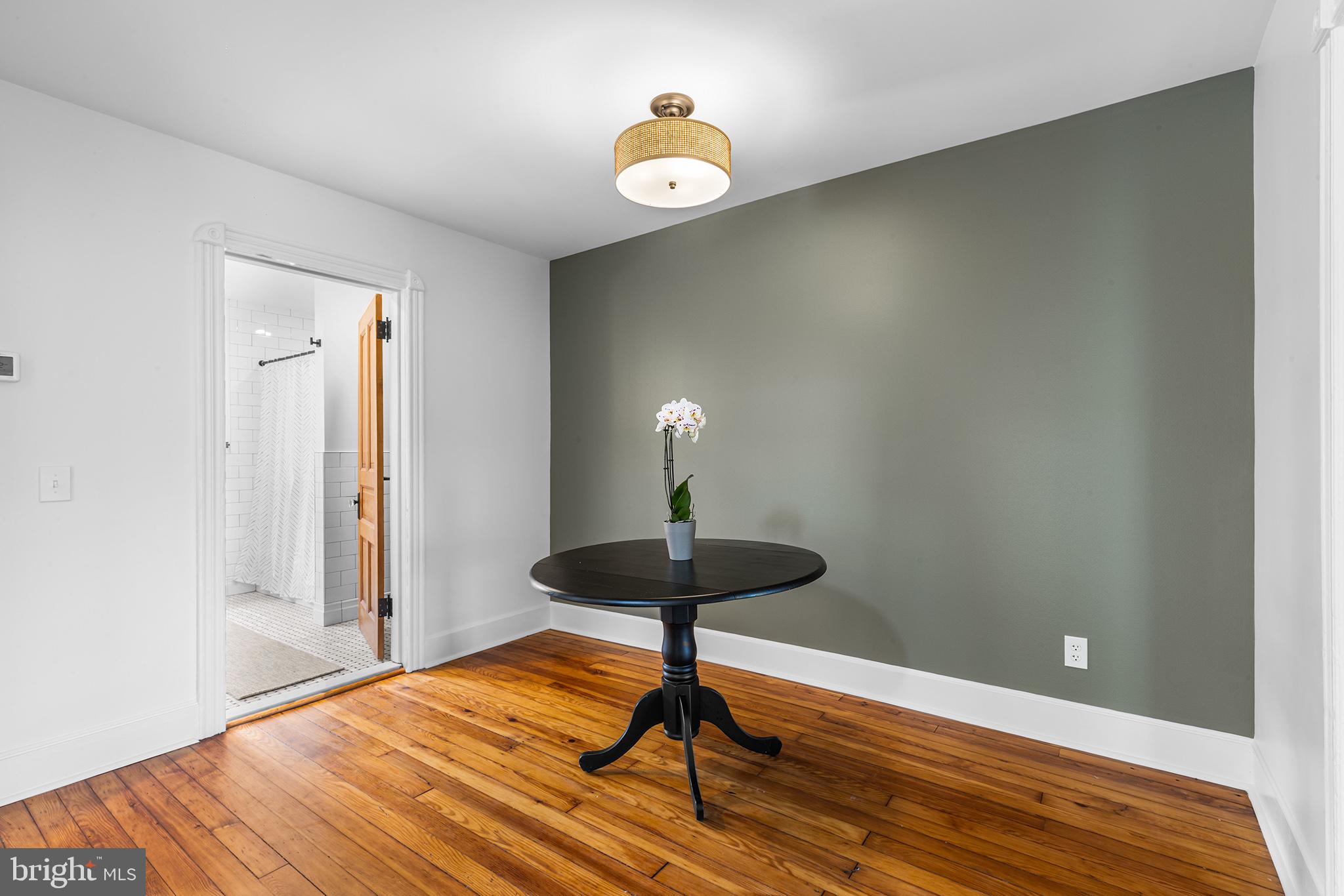 250 Conestoga Road, Unit 2 Wayne, PA 19087 - Photo 5 of 24 a lamp on a table & a chandelier