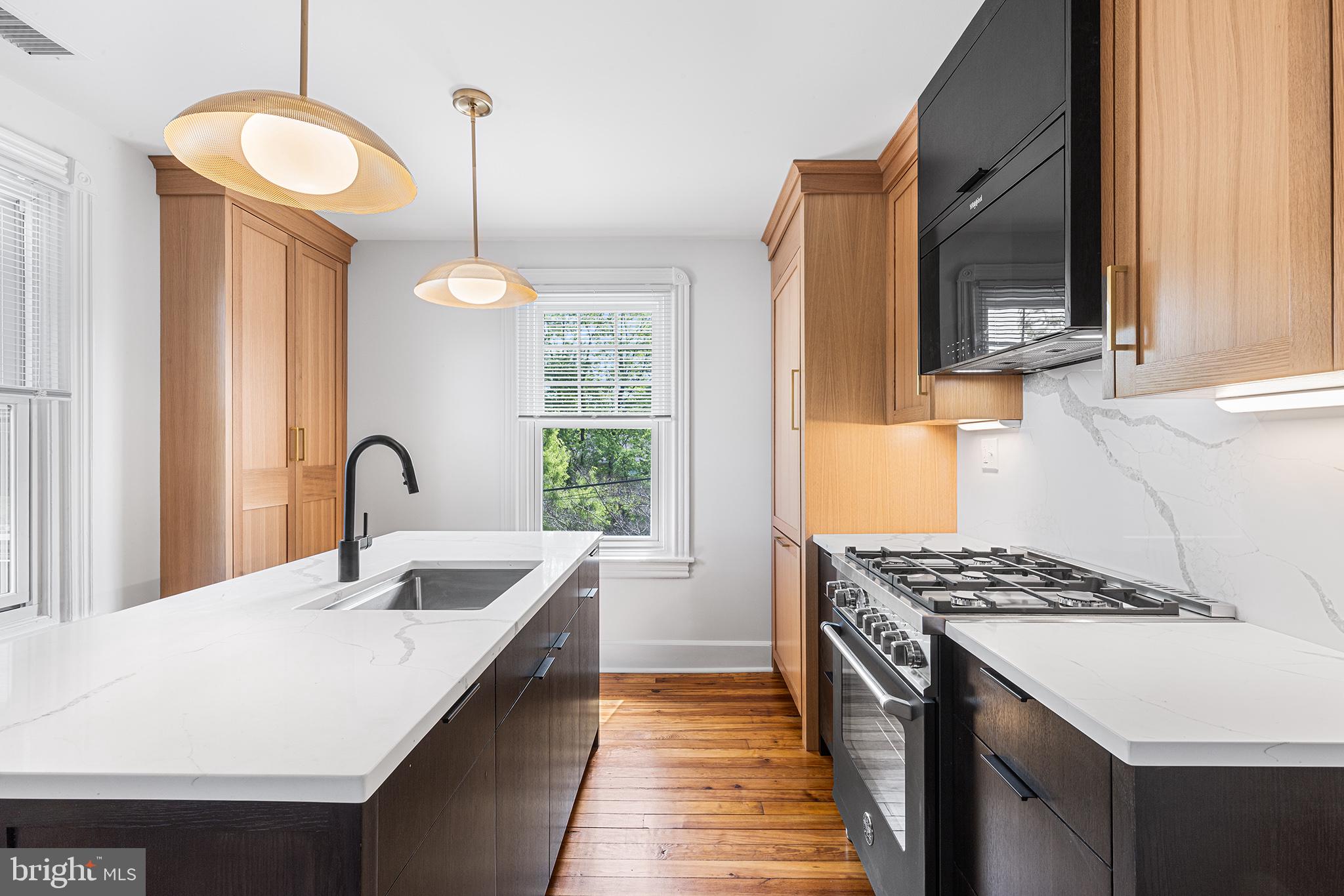 250 Conestoga Road, Unit 2 Wayne, PA 19087 - Photo 7 of 24 a kitchen with a sink stove and microwave