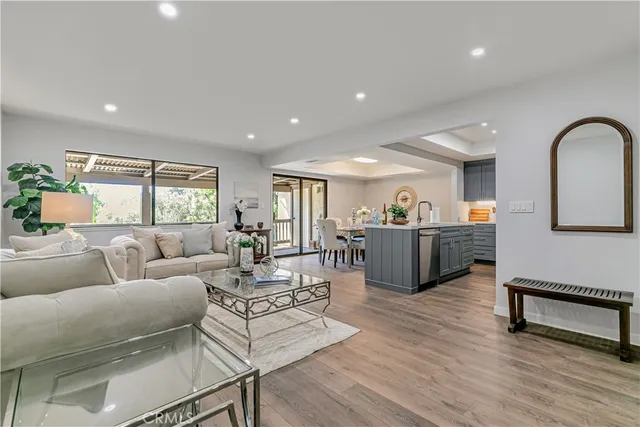 a living room with furniture potted plant and a window