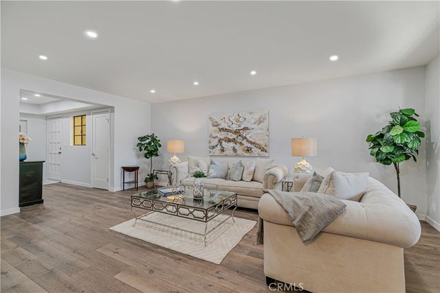 a kitchen with sink refrigerator and cabinets