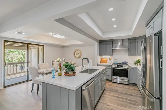 a kitchen with a stove a sink and a refrigerator