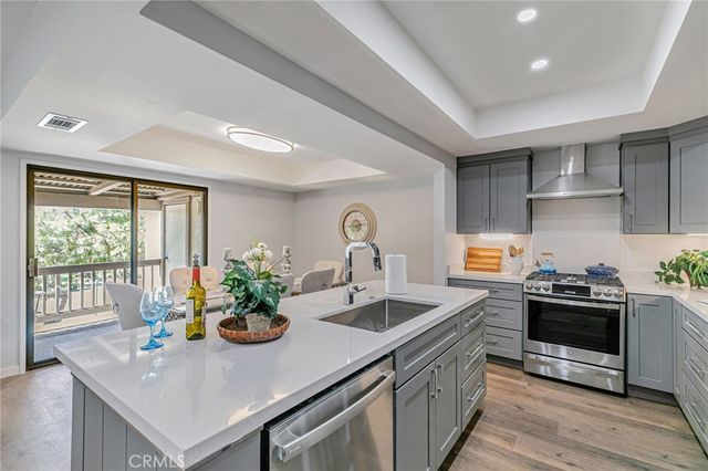 a kitchen with stainless steel appliances a refrigerator and a stove