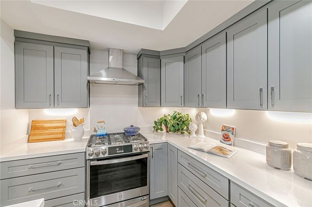 a kitchen with stainless steel appliances a stove and cabinets