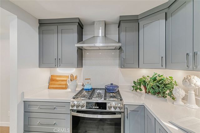 a kitchen with a refrigerator and a white cabinets