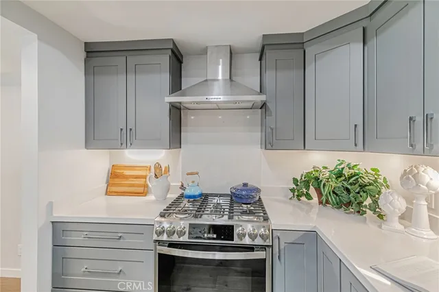 a kitchen with a refrigerator and a white cabinets