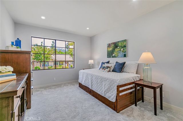 a bedroom with a bed and a lamp