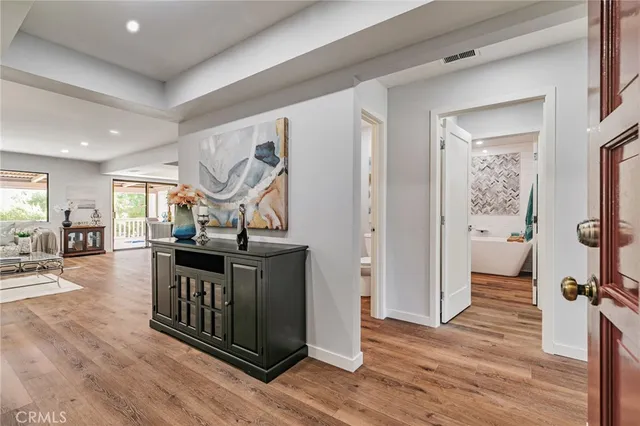 view of hall with wooden floor and cabinet