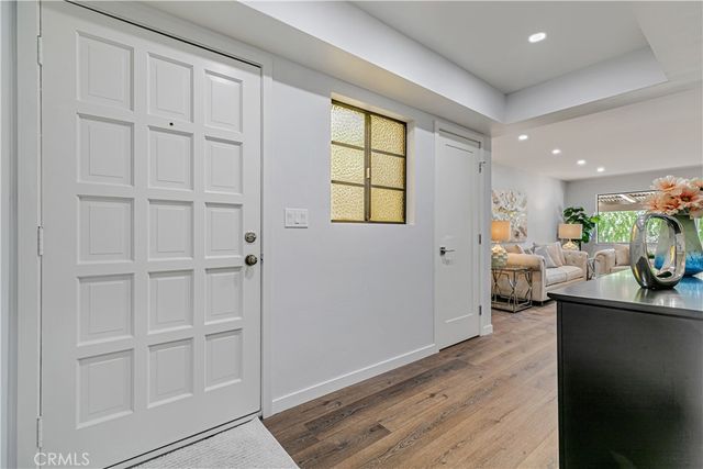 a view of hallway with wooden floor