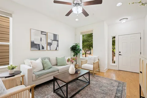 a living room with furniture and a wooden floor