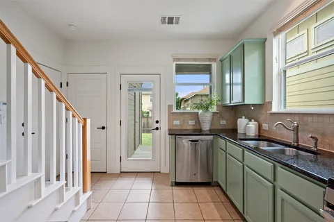 a kitchen with stainless steel appliances a sink stove and cabinets