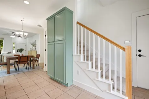 a view of a hallway with dining table and chairs