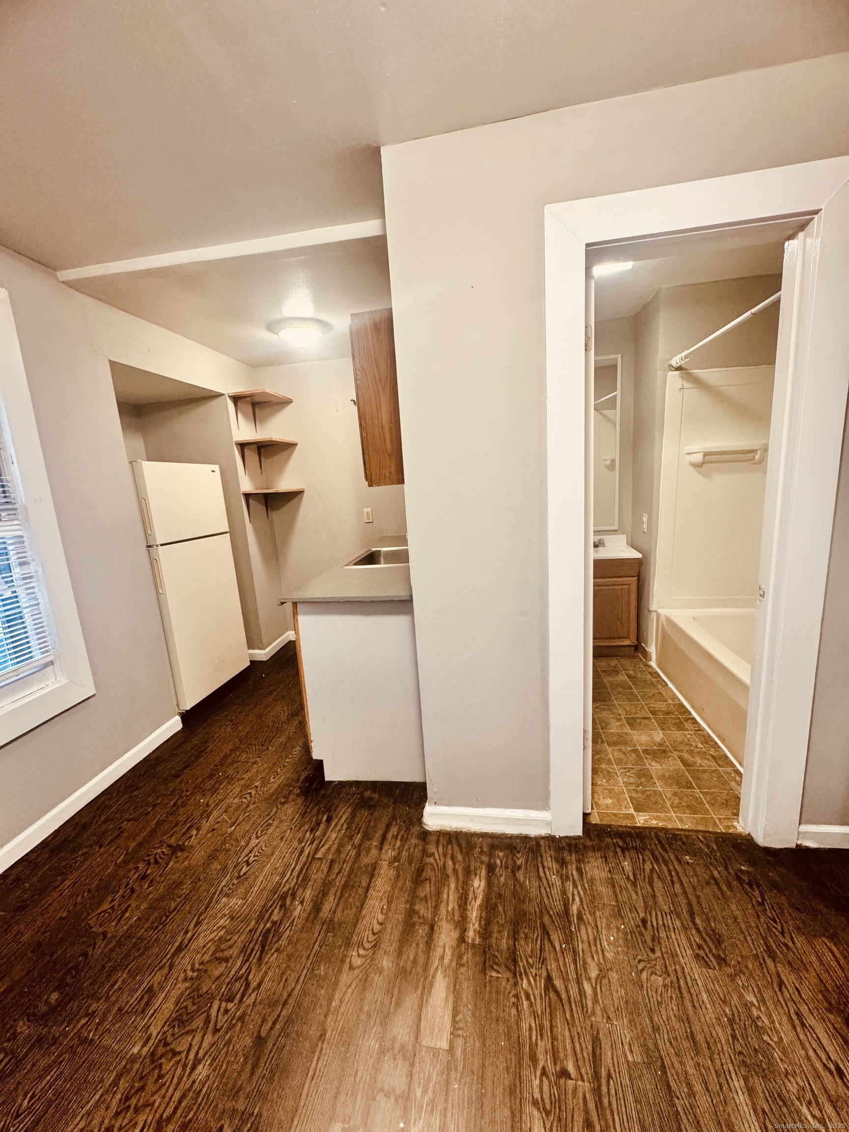 90 East Elm Street Torrington, CT 06790 - Photo 4 of 10 a view of empty room with wooden floor