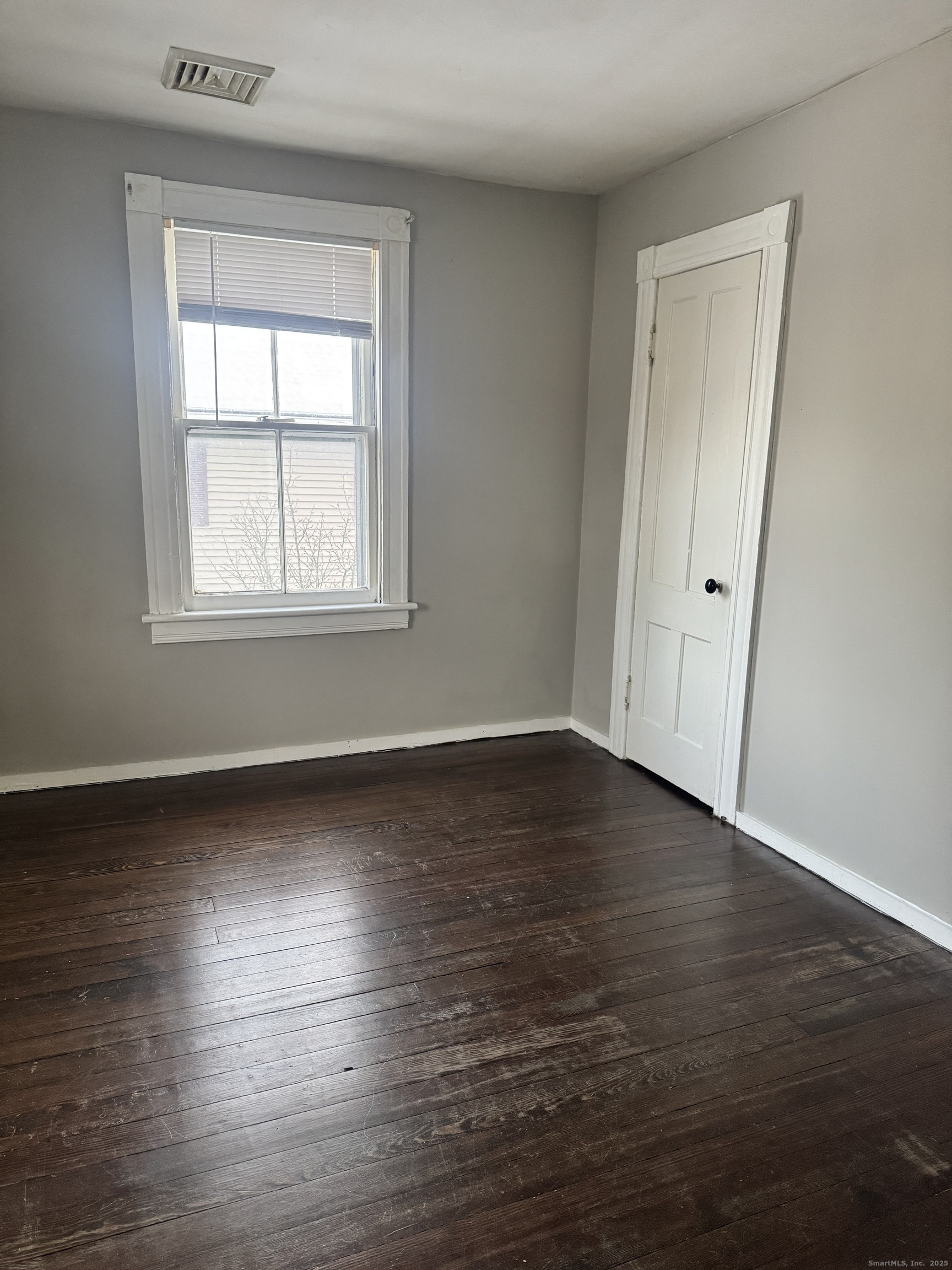 90 East Elm Street Torrington, CT 06790 - Photo 8 of 10 an empty room with wooden floor and windows