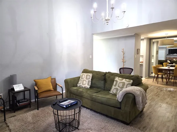 a living room with furniture a rug and a mirror