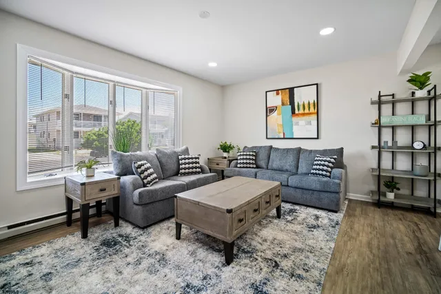 a living room with furniture and a wooden floor