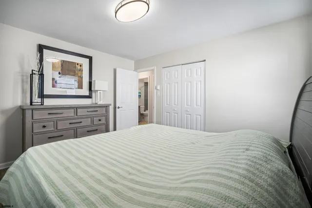 a bedroom with a bed and a dresser