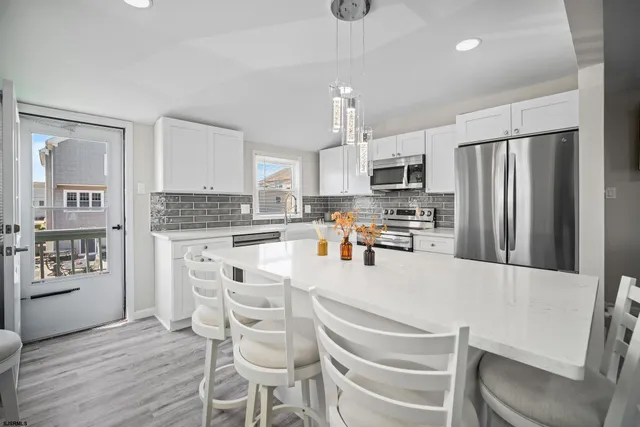 a kitchen with stainless steel appliances a refrigerator stove microwave and cabinets