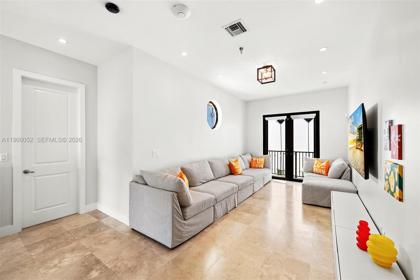 6001 Southwest 28th Street Miami, FL 33155 - Photo 16 of 30 a living room with furniture and a flat screen tv