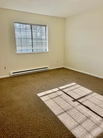an empty room with a white walls