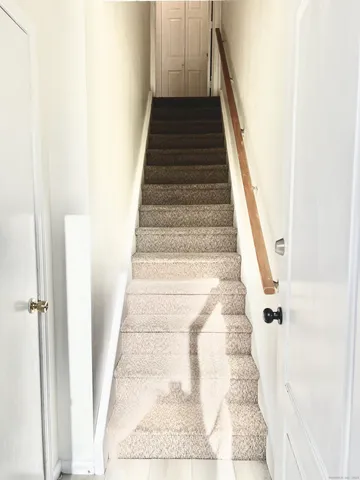 a view of staircase with white walls