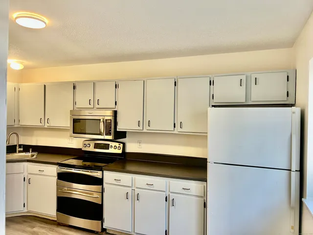 a white refrigerator freezer sitting in a kitchen