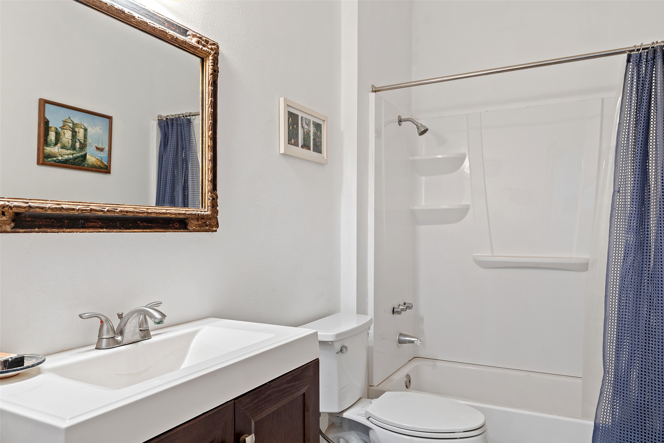 2966 Rm 165 Dripping Springs Dripping Springs, TX 78620 - Photo 13 of 23 Bathroom featuring a white vanity with an integrated sink, brushed nickel faucet, and a dark wood-finish cabinet