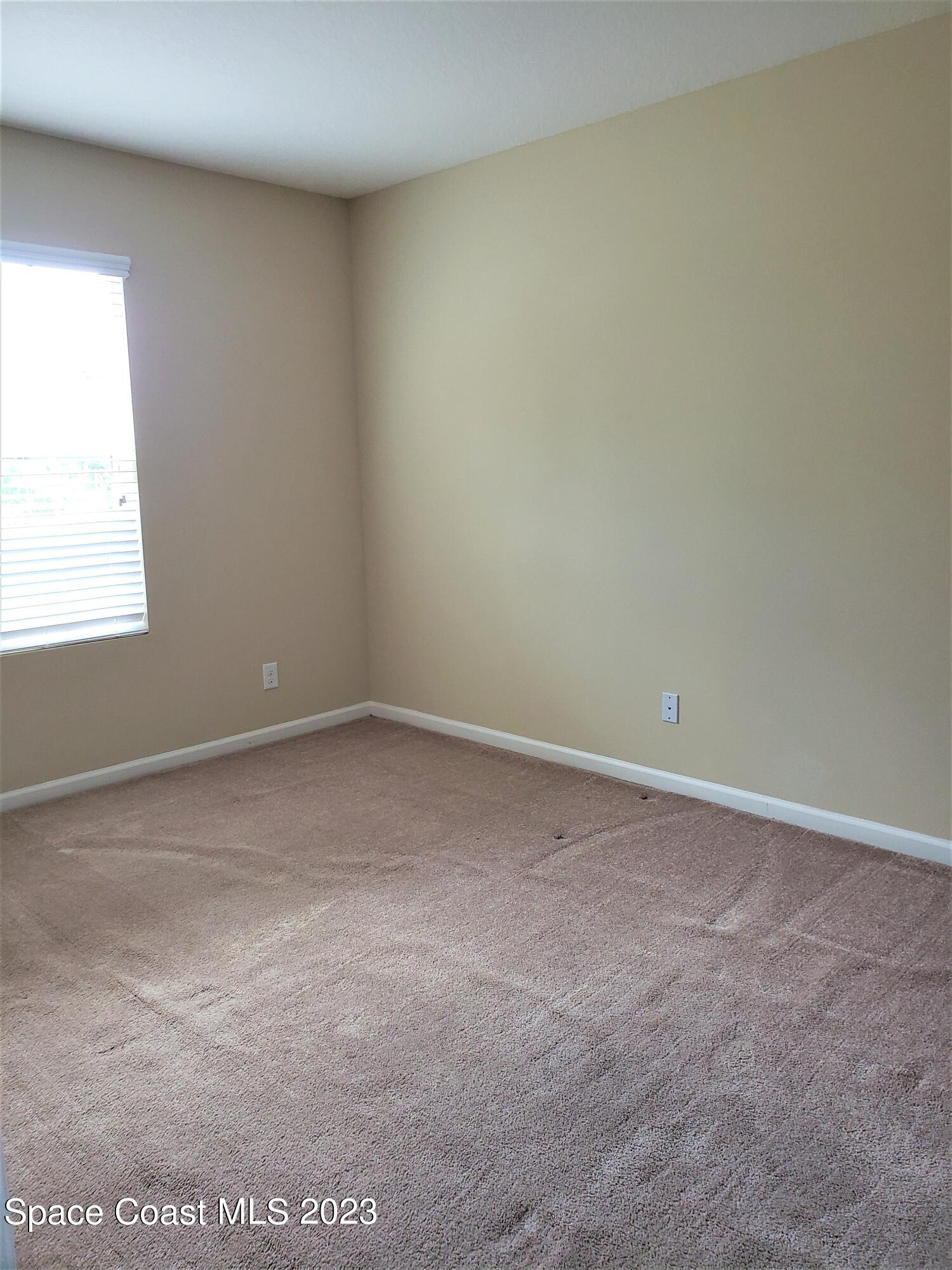 2575 Revolution Street, Unit 105 Melbourne, FL 32935 - Photo 13 of 38 an empty room with a window