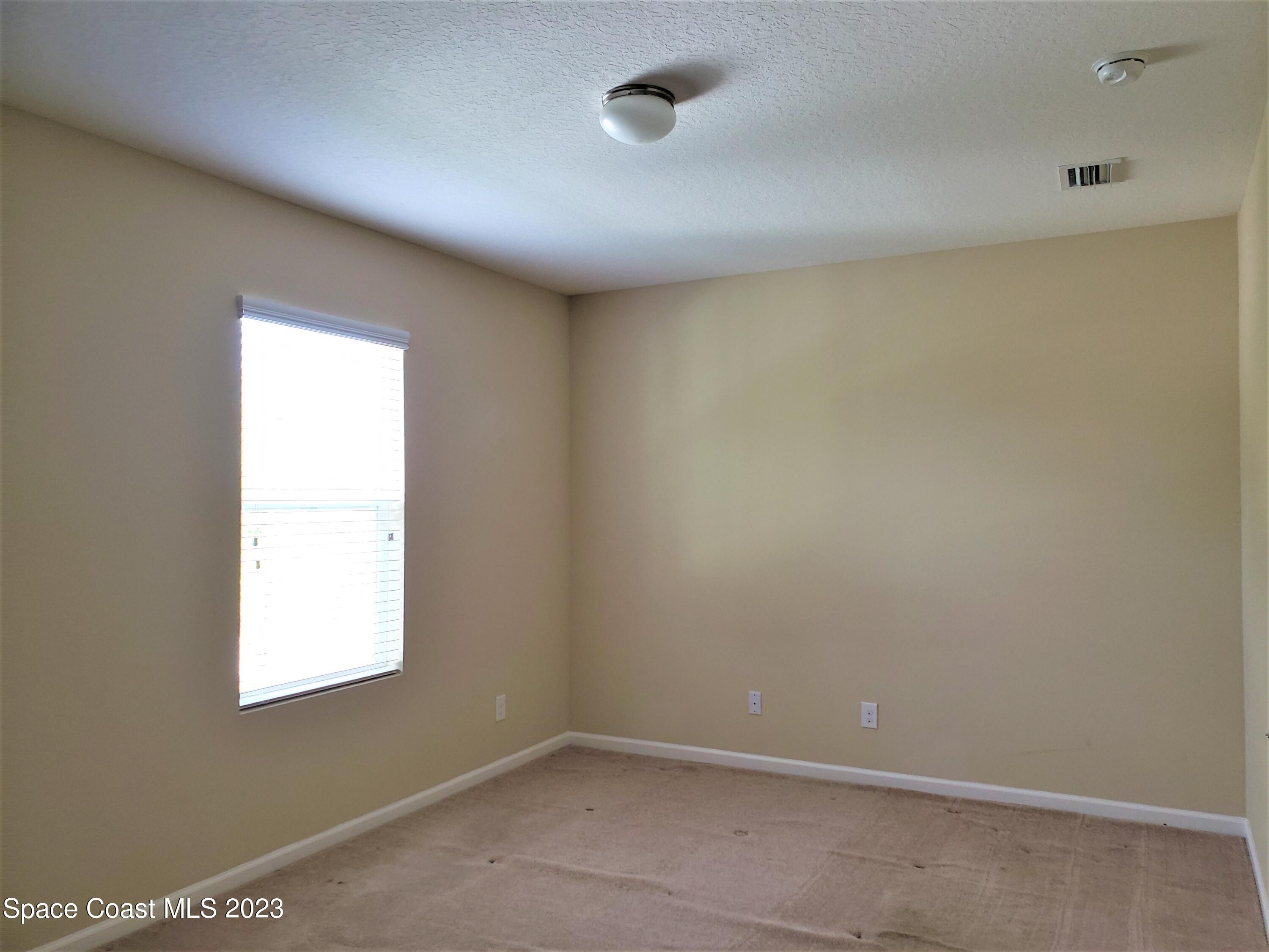 2575 Revolution Street, Unit 105 Melbourne, FL 32935 - Photo 16 of 38 an empty room with a window