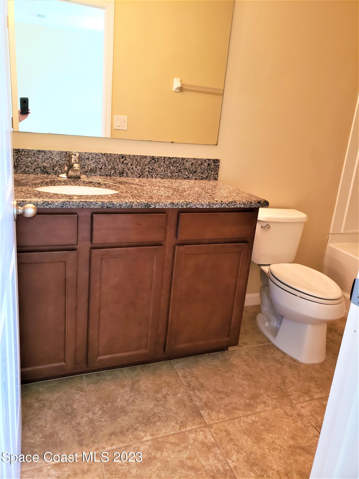 2575 Revolution Street, Unit 105 Melbourne, FL 32935 - Photo 19 of 38 a bathroom with a toilet