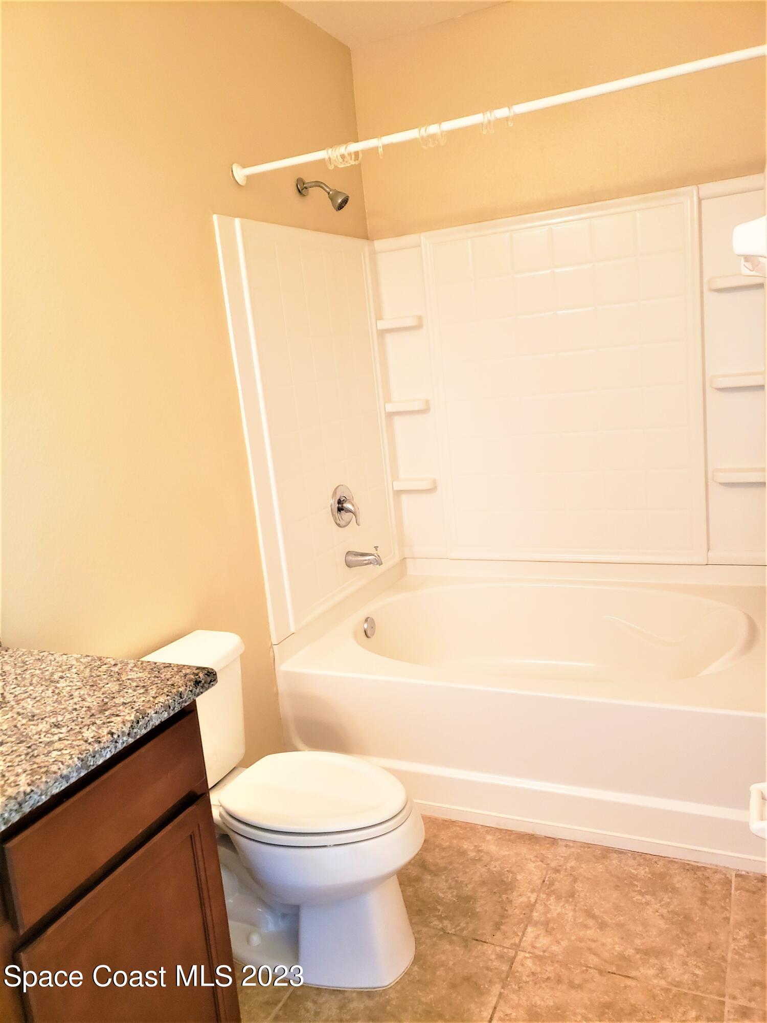 2575 Revolution Street, Unit 105 Melbourne, FL 32935 - Photo 20 of 38 a bathroom with a toilet and a shower