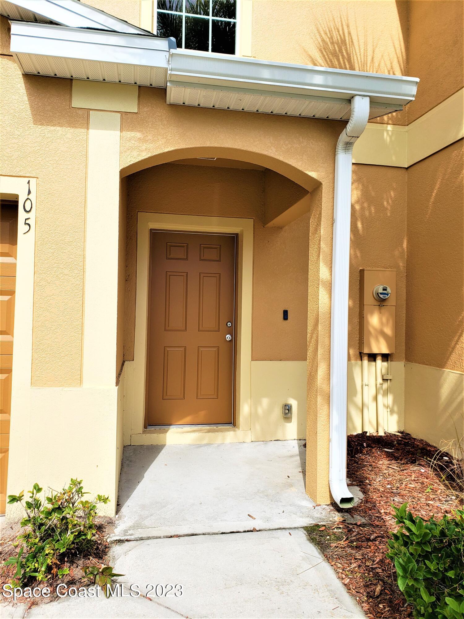 2575 Revolution Street, Unit 105 Melbourne, FL 32935 - Photo 2 of 38 a entrance to a house with yard