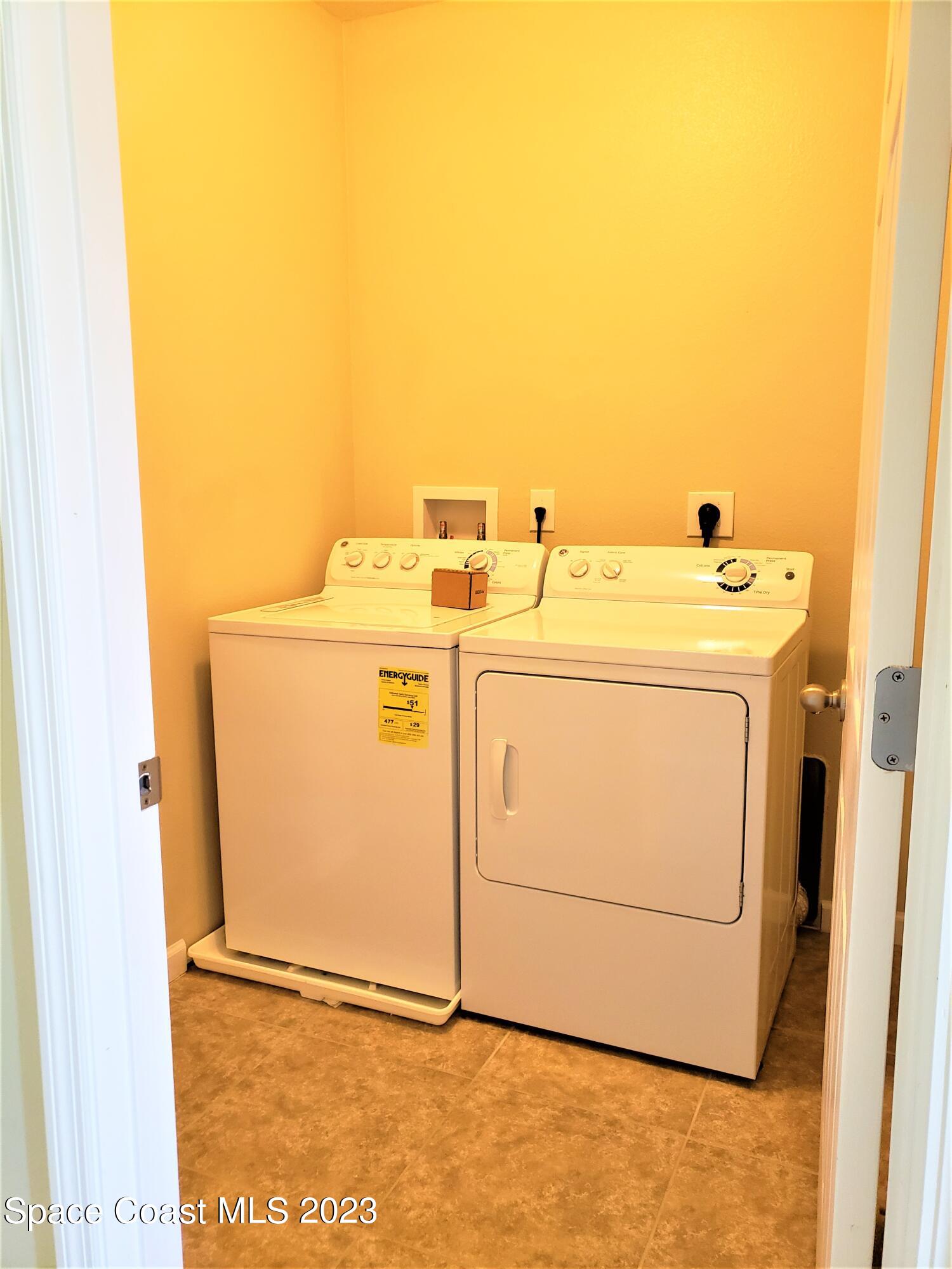 2575 Revolution Street, Unit 105 Melbourne, FL 32935 - Photo 21 of 38 a utility room with dryer and washer