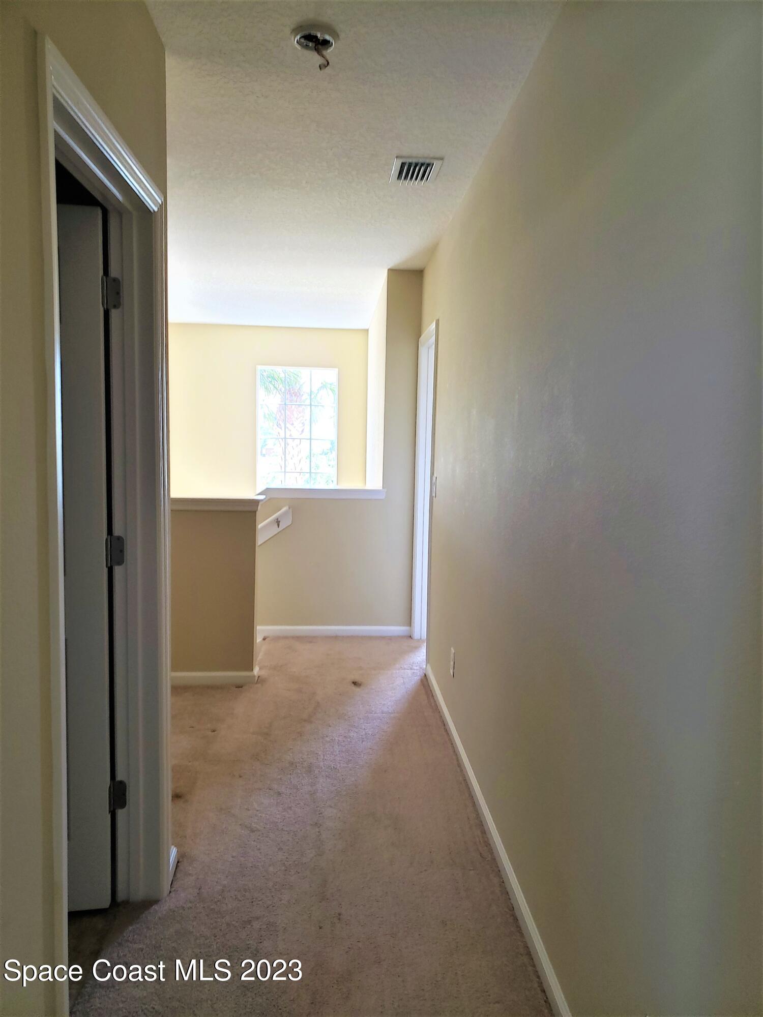 2575 Revolution Street, Unit 105 Melbourne, FL 32935 - Photo 22 of 38 a view of an empty room and window