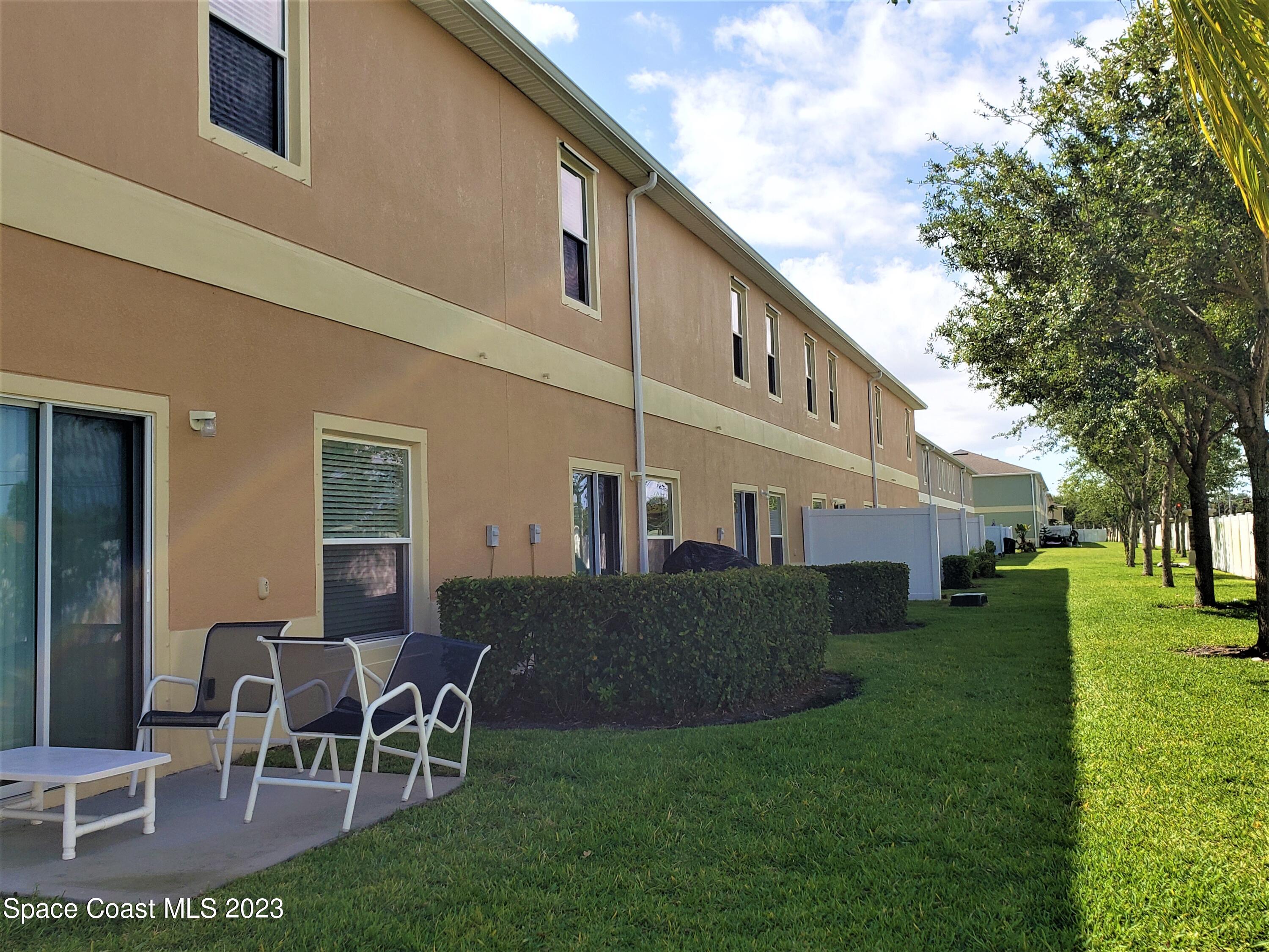 2575 Revolution Street, Unit 105 Melbourne, FL 32935 - Photo 25 of 38 a view of a house with a yard and sitting area