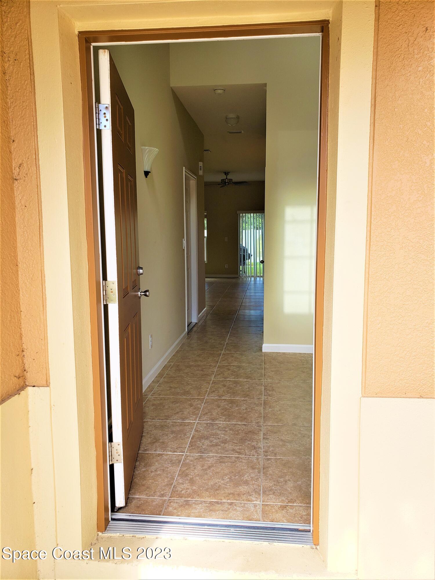 2575 Revolution Street, Unit 105 Melbourne, FL 32935 - Photo 3 of 38 a view of a hallway with wooden floor