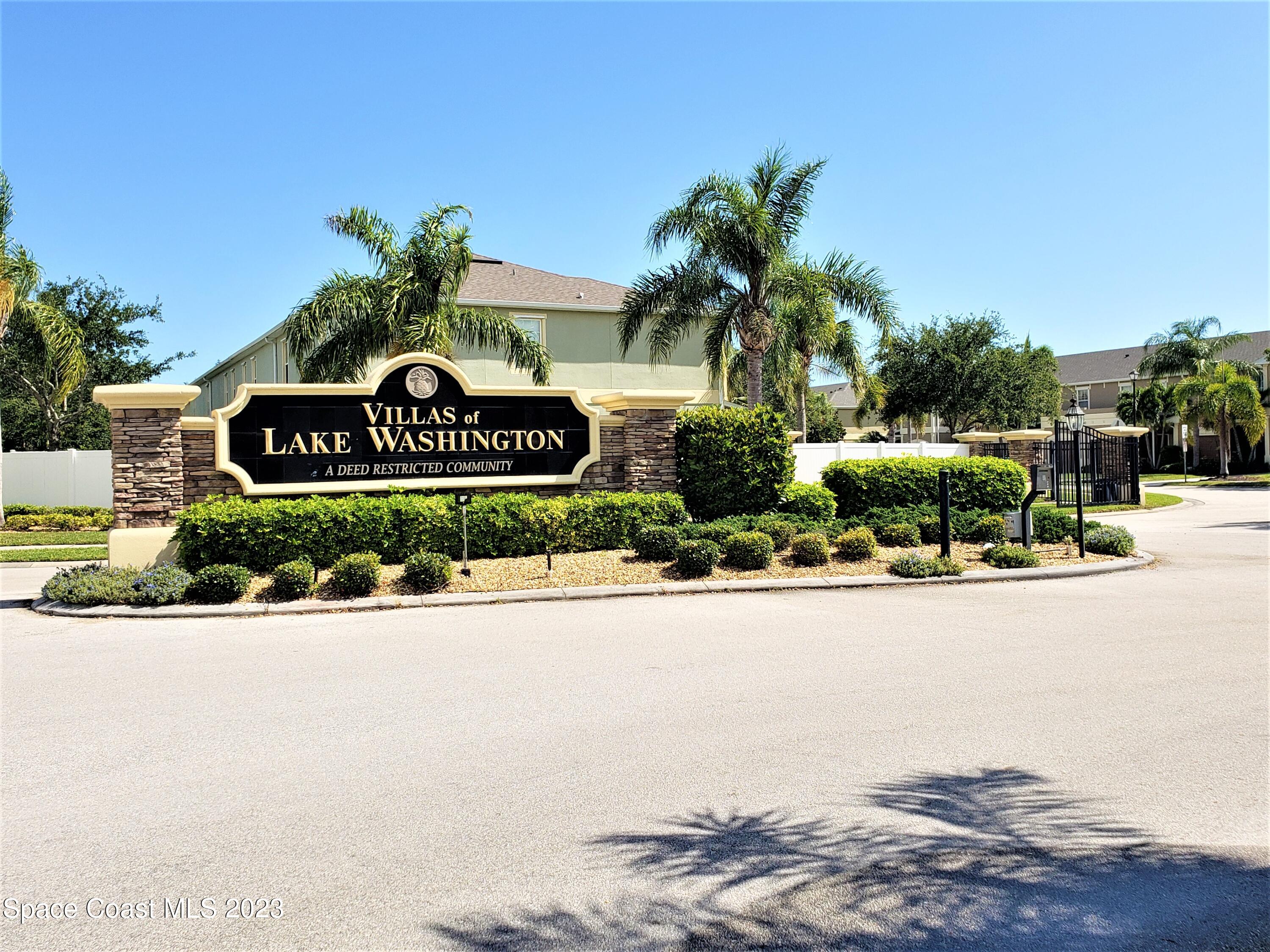 2575 Revolution Street, Unit 105 Melbourne, FL 32935 - Photo 32 of 38 a front view of a house with a yard and garage