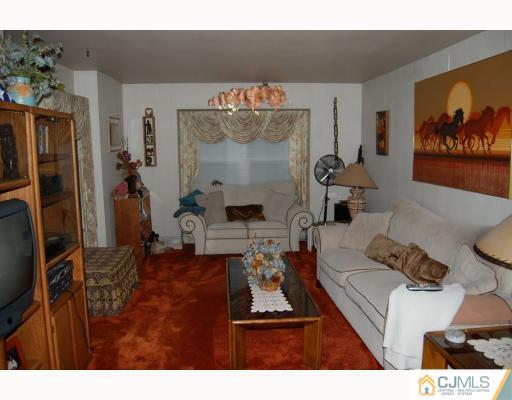 48 Pinecrest Road Somerset, NJ 08873 - Photo 3 of 10 a living room with furniture and a flat screen tv