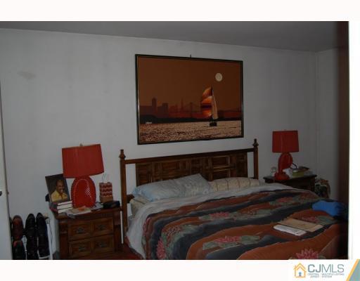 48 Pinecrest Road Somerset, NJ 08873 - Photo 7 of 10 a bedroom with a bed and a painting on the wall