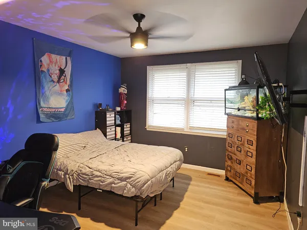 a bedroom with a bed dresser and a window