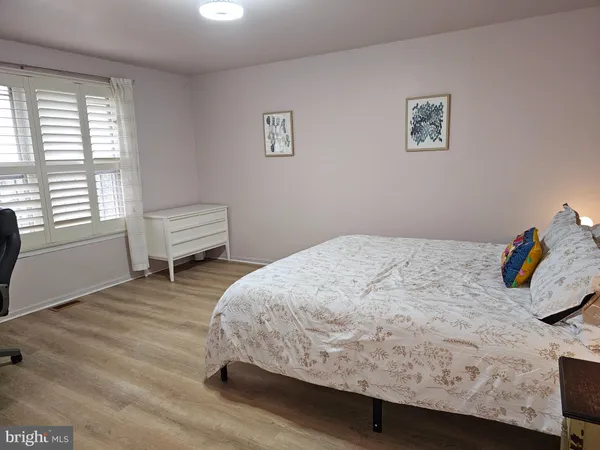 a bedroom with a bed and a chair