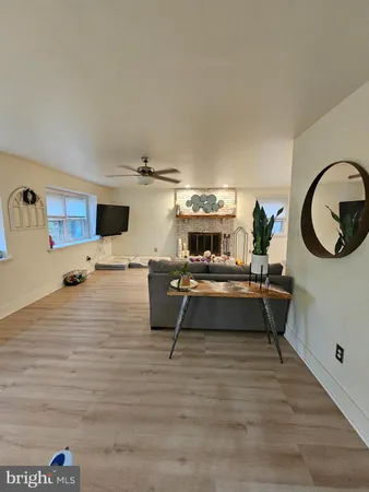 a living room with furniture and a mirror
