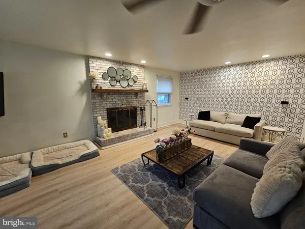 a living room with furniture and a fireplace