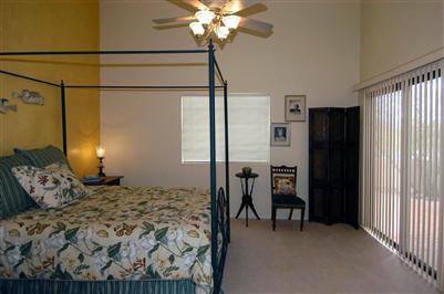 4992 North Valle Road Tucson, AZ 85750 - Photo 6 of 10 a bedroom with a bed and a chandelier