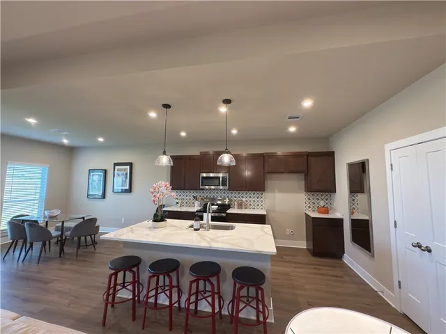 a workspace area with wooden floor and furniture