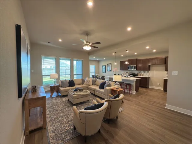 a spacious bedroom with a bed and a chandelier