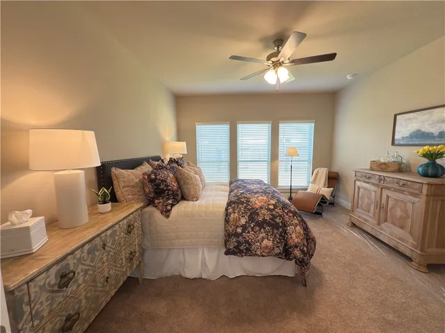 a view of a hallway with wooden floor and a living room