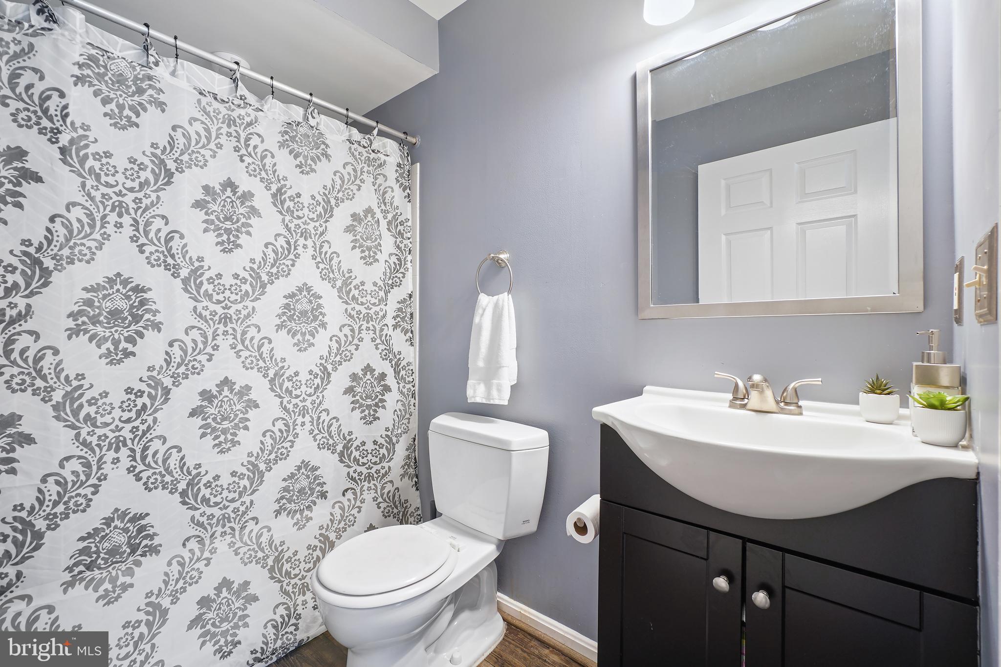 14151 Cuddy Loop, Unit 101 Woodbridge, VA 22193 - Photo 14 of 45 a bathroom with a sink toilet and a mirror