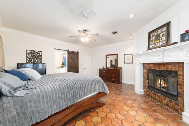 a spacious bedroom with a bed and a fireplace