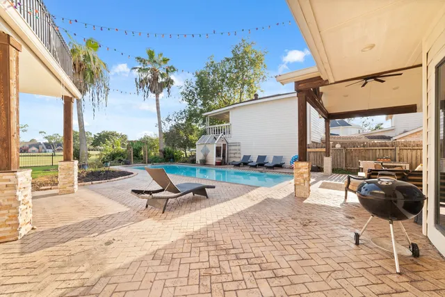 a swimming pool with outdoor seating and patio
