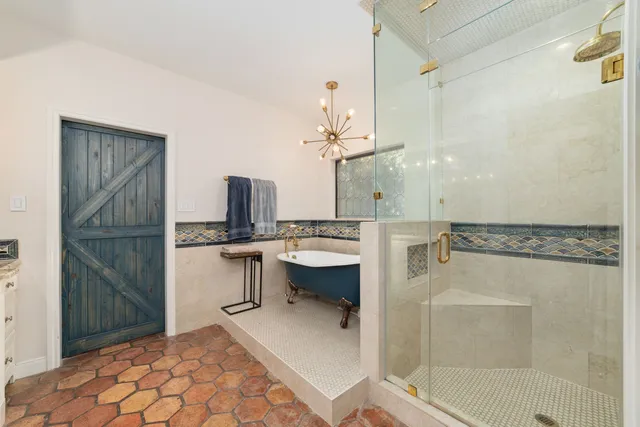 a bathroom with a double vanity sink mirror and shower